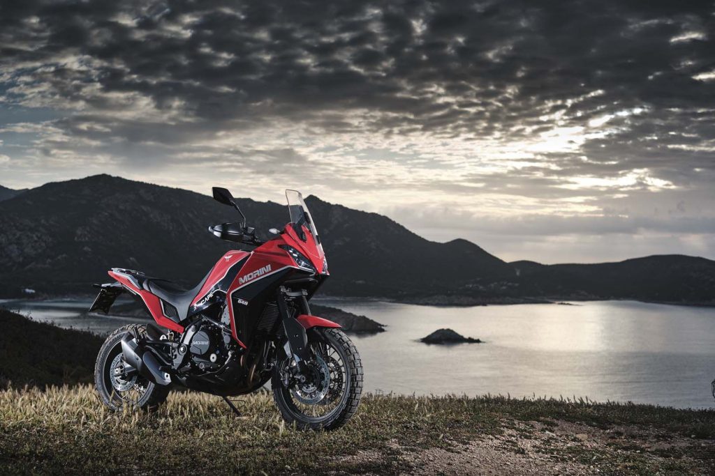 视图的骑手尝试全新的摩托Morini X-Cape冒险摩托车在崎岖的地形,用华丽的热带视图。